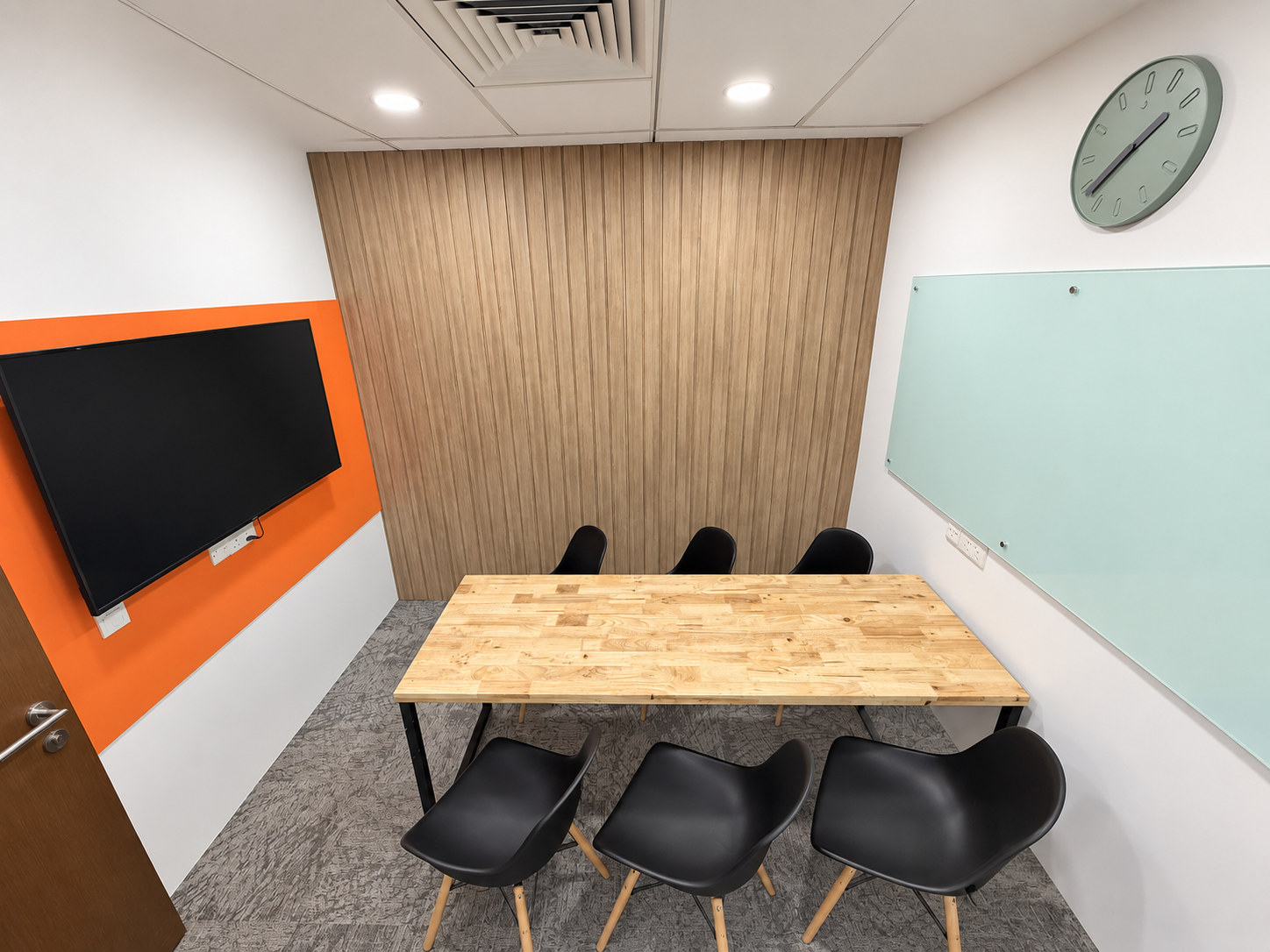 Meeting room with table, display and glass board